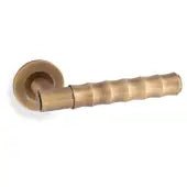 Alexander & Wilks Spitfire Bamboo Lever on Rose in a warm brass finish, featuring a textured bamboo-style grip and a circular rose backplate.