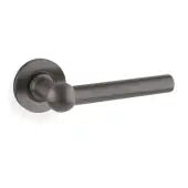 Alexander & Wilks Siskin Lever on Rose in a dark finish, featuring a cylindrical handle and round rose plate for door hardware.