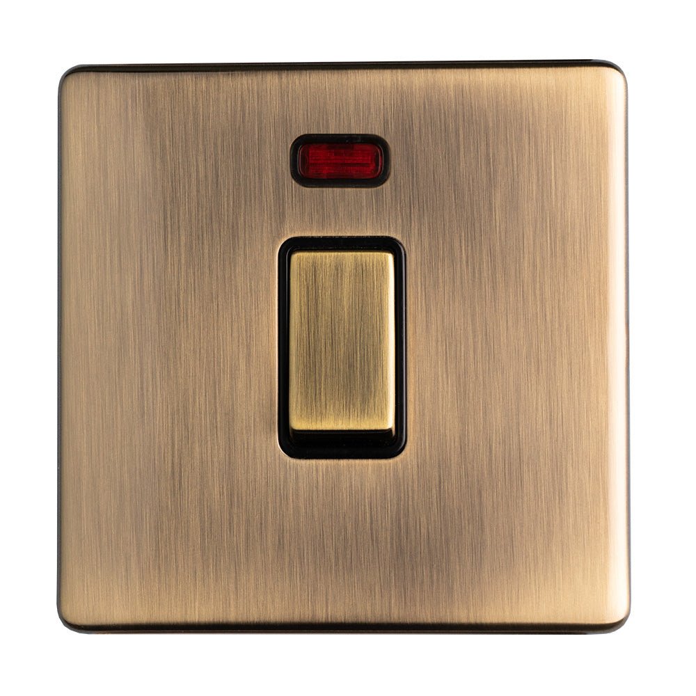 Eurolite Concealed 3mm 20Amp Switch With Neon Indicator in antique brass finish, featuring a rectangular toggle switch and a small red indicator light above.