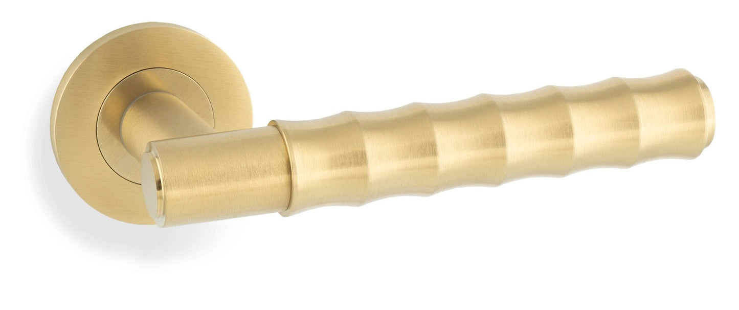 Alexander & Wilks Spitfire Bamboo Lever on Rose in a brushed gold finish, featuring a textured, cylindrical handle with a round rose plate.