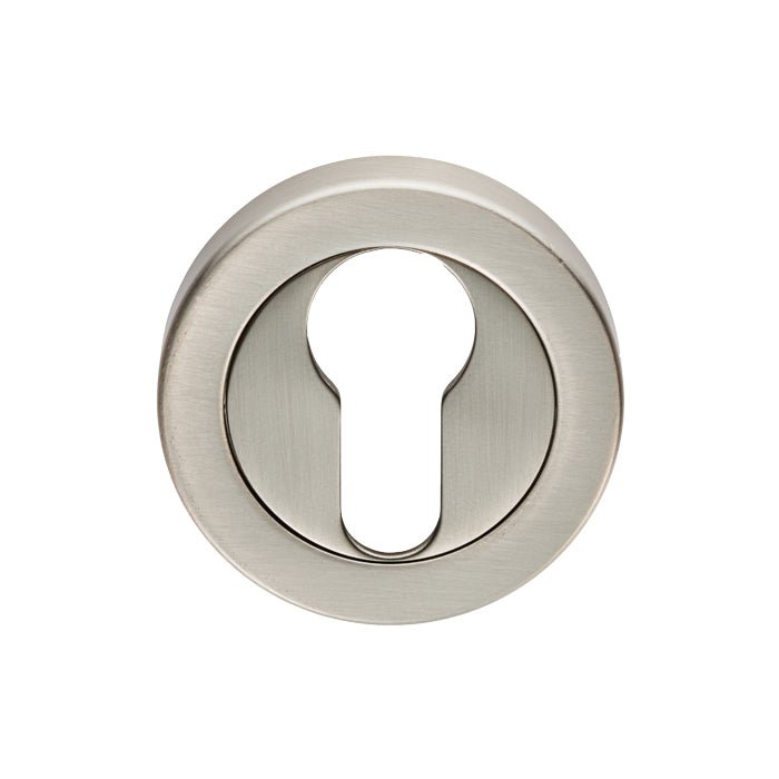 Carlisle Brass Euro Escutcheons in satin nickel, featuring a circular shape with a keyhole cutout for locking mechanisms. The surface has a brushed finish, adding a sleek look.
