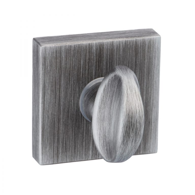 Atlantic Forme WC Turn in brushed nickel finish features a square back plate with a rounded knob, showcasing a textured surface.