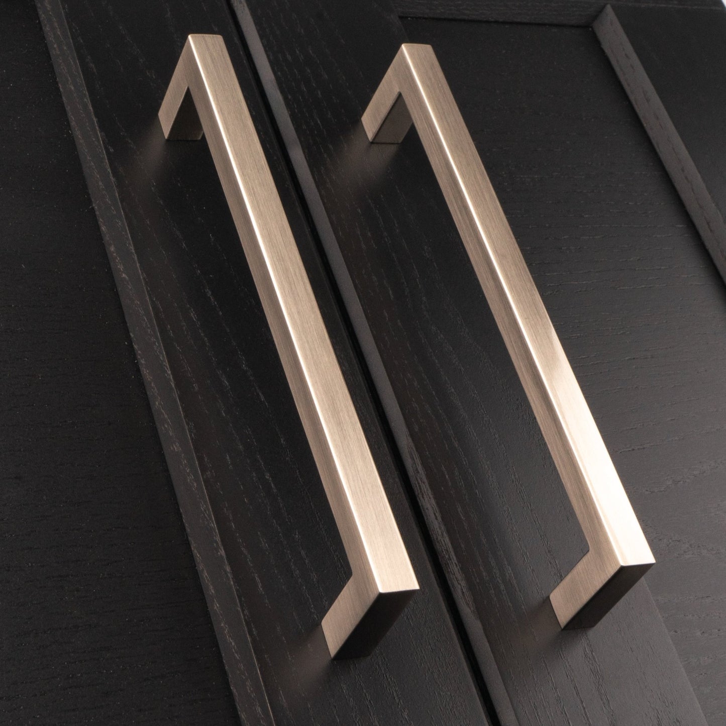 Carlisle Brass Block Handle in a brushed nickel finish, featuring a modern rectangular design with a smooth surface. The handle is shown on a dark wood cabinet, emphasizing its sleek lines and contemporary style.
