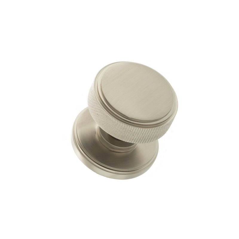 Atlantic Millhouse Brass Harrison Brass Knurled Mortice Knob on Concealed Fix Rose with a brushed brass finish, featuring a round shape and knurled texture for grip, designed to complement various door styles.