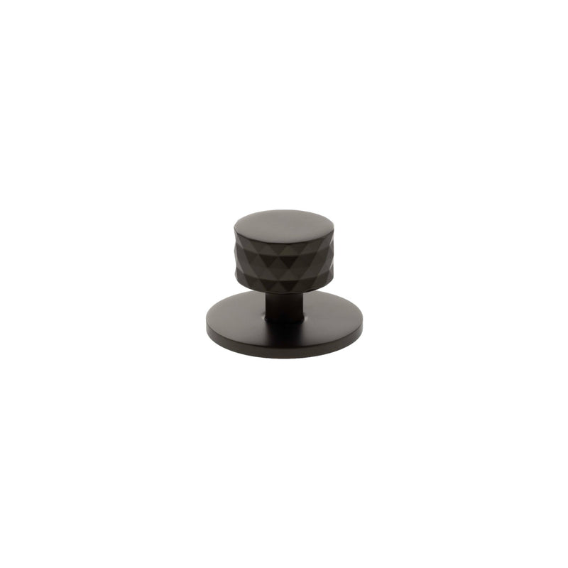 Atlantic Millhouse Brass Chrysler Diamond Round Cabinet Knob Handle on Backplate in a dark finish, featuring a diamond pattern on the knob and a circular backplate.