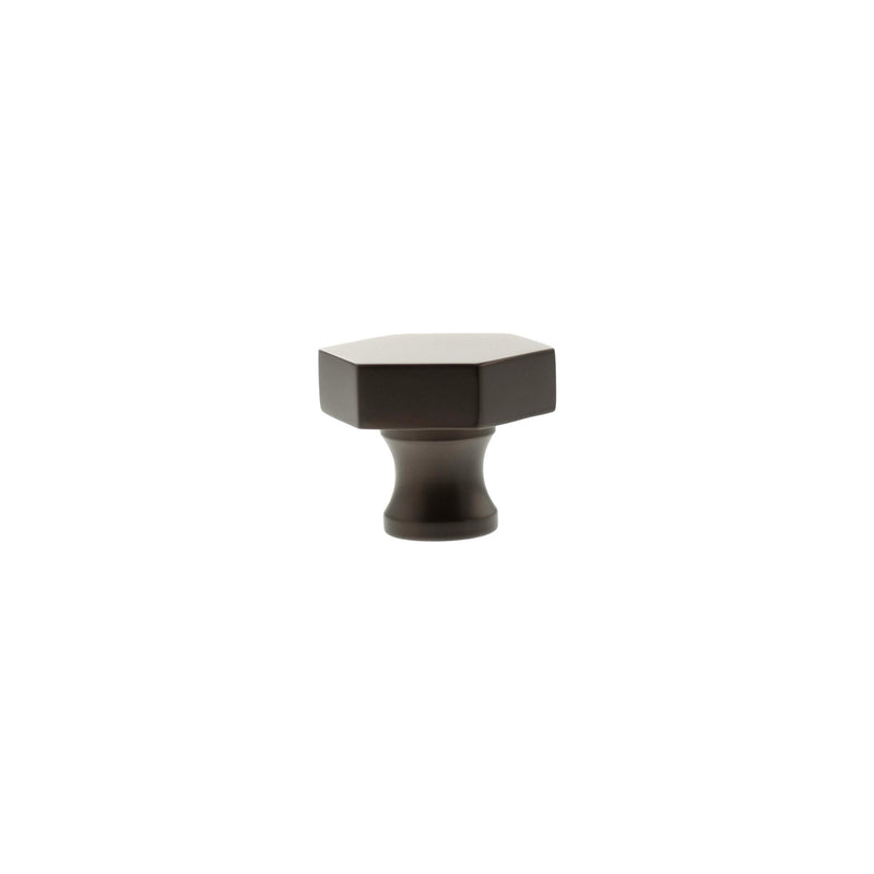 Atlantic Millhouse Brass Pennington Hexagonal Cabinet Knob Handle in a dark finish, featuring a hexagonal top and a tapered base for secure attachment.