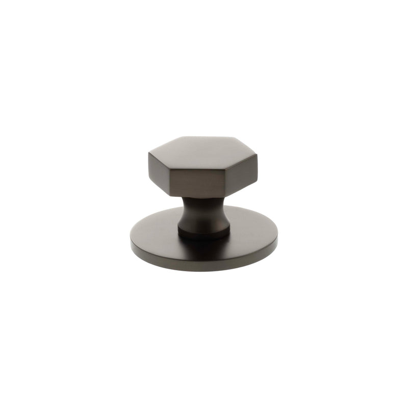 Atlantic Millhouse Brass Pennington Hexagonal Cabinet Knob Handle on Backplate in a dark finish, featuring a hexagonal knob design mounted on a circular backplate.