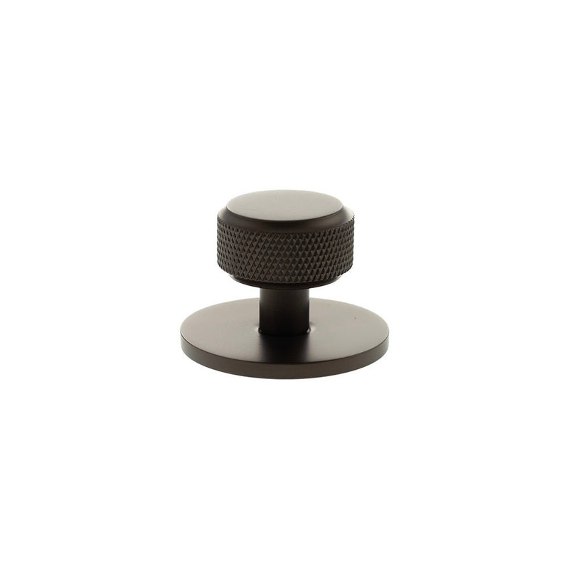 Atlantic Millhouse Brass Eiffel Knurled Round Cabinet Knob Handle on Backplate in a dark finish, featuring a textured knurled design on the knob and a round base.