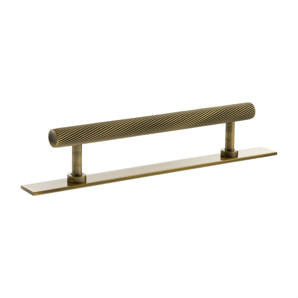 Atlantic Millhouse Brass Paddington Spiral T-Bar Cabinet Pull Handle on Backplate, measuring 128mm in length, features a ribbed design on the handle with a smooth backplate, finished in a warm brass tone.
