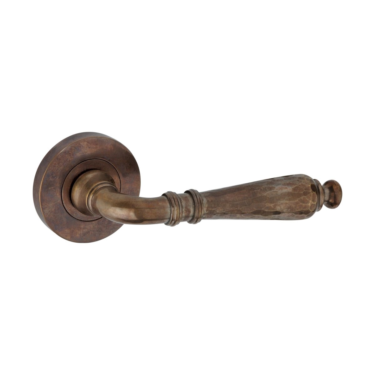 Spira Brass Hammered Hazel Lever on Rose in a warm, antique brass finish, featuring a textured lever design and a circular rose base for mounting.