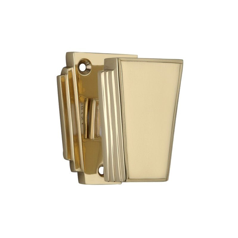 Spira Brass Triago Door Knob in a polished brass finish with a geometric design, featuring a rectangular shape and subtle ridges for texture.