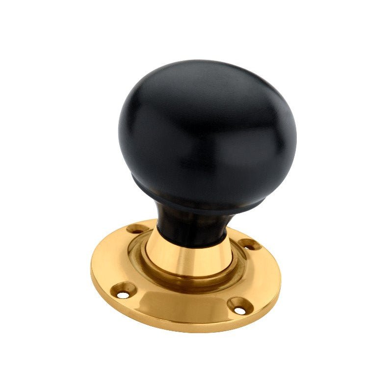 Spira Brass Ebony Bun Rim/Mortice Door Knob featuring a round black knob and a polished brass base plate, designed for door installations.
