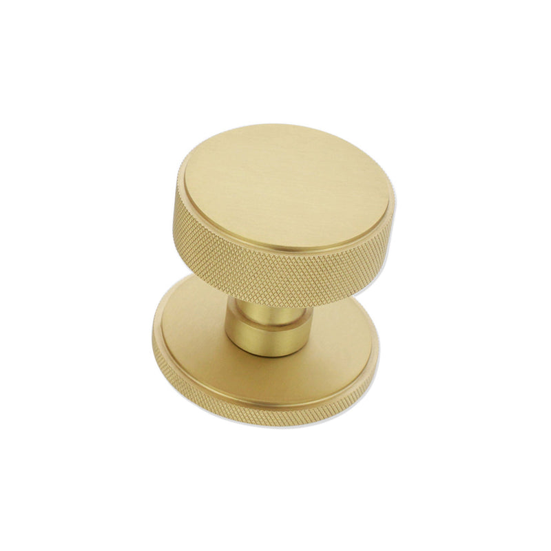 Spira Brass Connaught Knurled Door Knob in a brushed brass finish, featuring a smooth circular top and textured knurled edges for grip.
