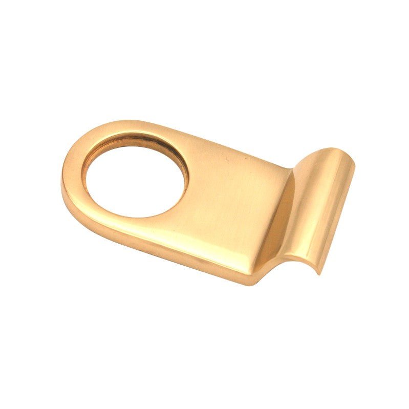 Spira Brass Victorian Cylinder Pull in polished brass finish, featuring a round opening and an angled edge, designed for elegant cabinetry or furniture.