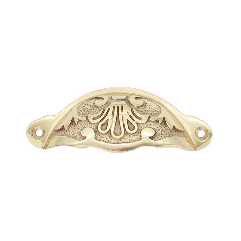 Spira Brass Floral Cup Pull in a polished brass finish, featuring an ornate design with curved edges and decorative detailing, suitable for cabinets and drawers.