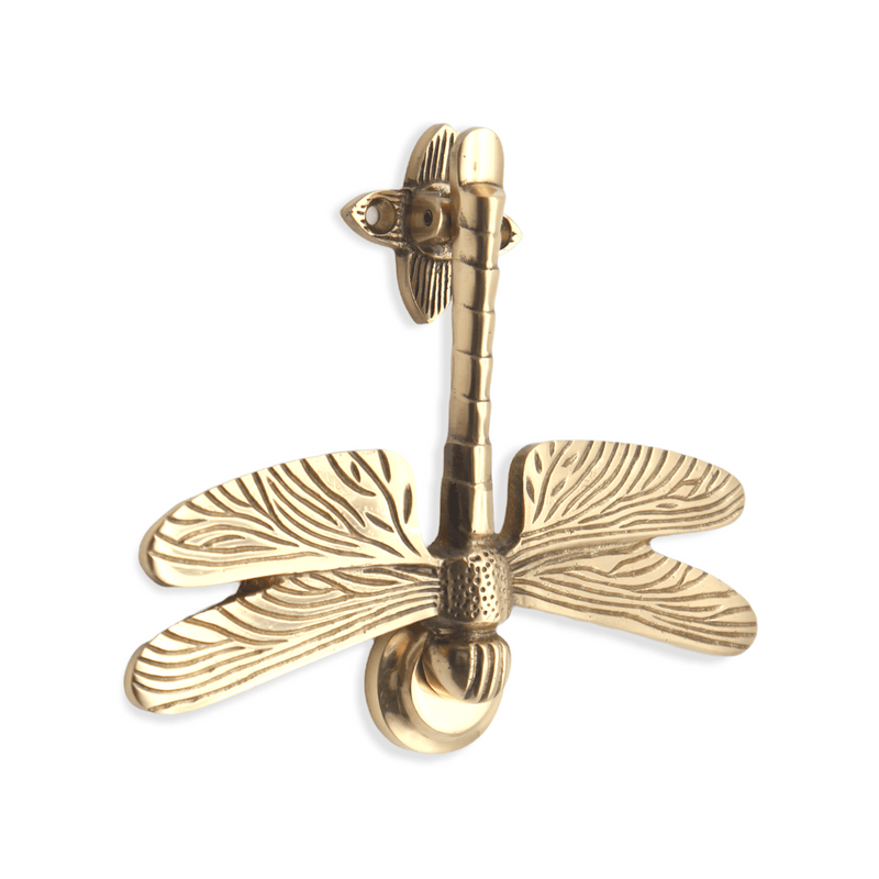 Spira Brass Dragonfly Door Knocker in a polished brass finish, featuring detailed wings and body design, mounted on a backplate for easy installation.