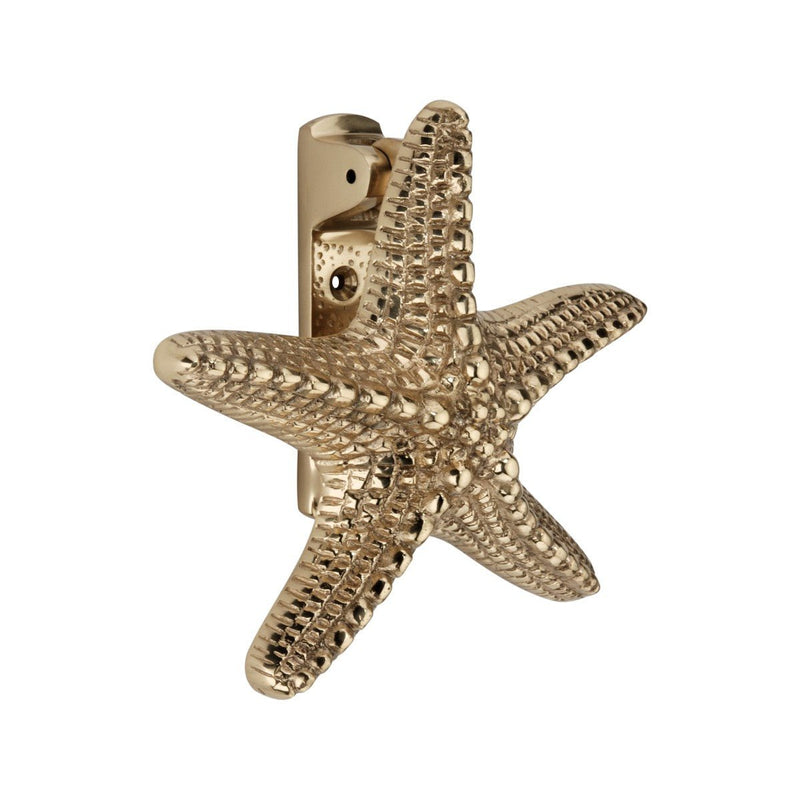 Spira Brass Starfish Door Knocker in a polished gold finish, featuring a detailed starfish design with textured surface and a sturdy mounting bracket.