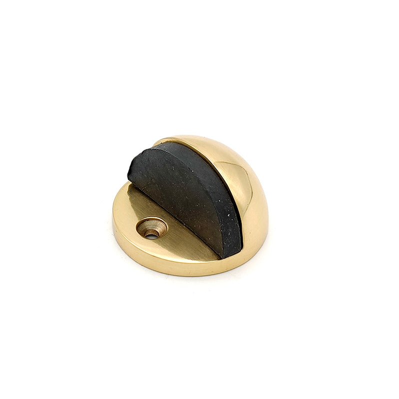 Spira Brass Half Moon Door Stopper featuring a polished brass finish with a curved design and a rubber insert for grip, shown with a screw hole for mounting.