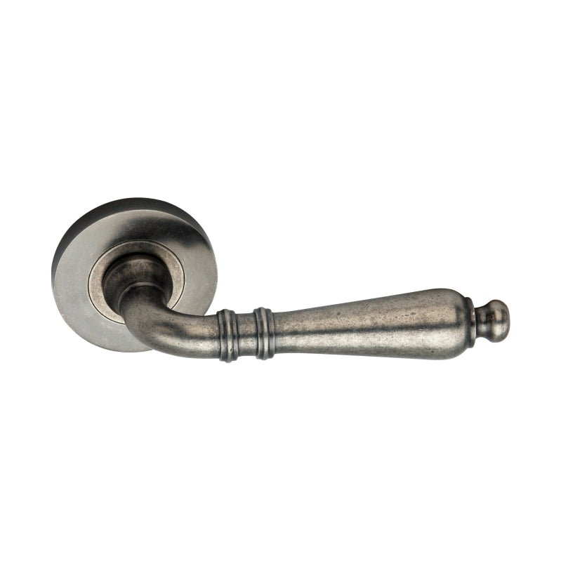 Spira Brass Hazel Lever Door Handle in a brushed nickel finish, featuring a tapered lever with decorative grooves and a round rosette base for mounting.