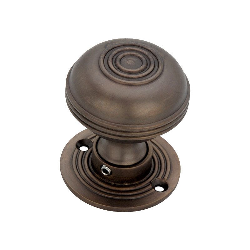 Spira Brass Bloxwich 50mm Rim/Mortice Door Knob in a dark bronze finish, featuring a rounded design with concentric rings, mounted on a circular base with three screw holes for installation.
