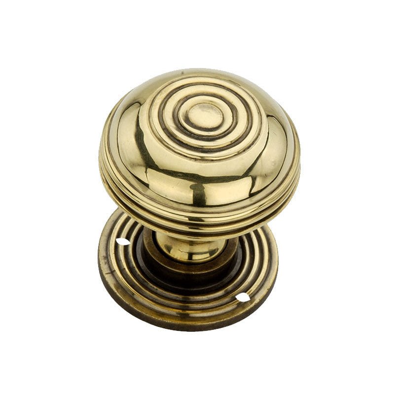 Spira Brass Bloxwich 50mm Rim/Mortice Door Knob in polished brass, featuring a round design with concentric rings and a base plate for mounting.