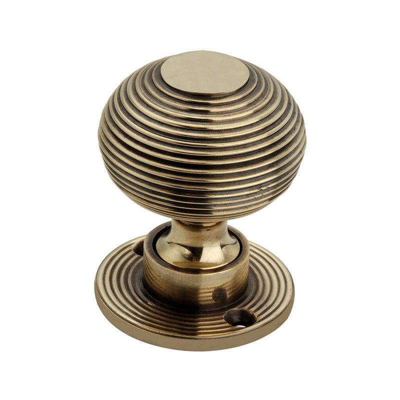 Spira Brass Beehive 50mm Rim/Mortice Door Knob in antique brass finish, featuring a round ribbed design with a circular base and a single mounting hole.