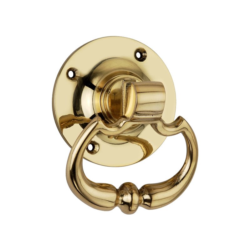 Spira Brass Dutch Drop handle in polished brass finish, featuring a circular backplate and an ornate drop handle design, suitable for doors or cabinets.