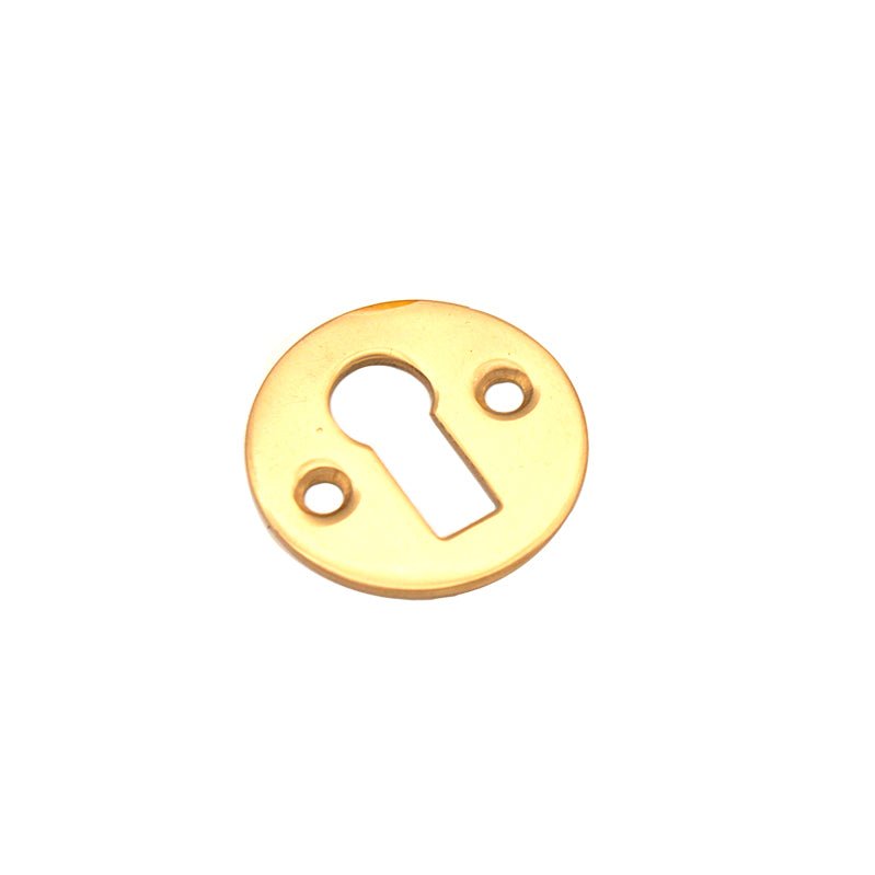 Spira Brass Victorian Key Hole Open Escutcheon in a polished brass finish, featuring a circular design with an oval keyhole and two mounting holes for installation.
