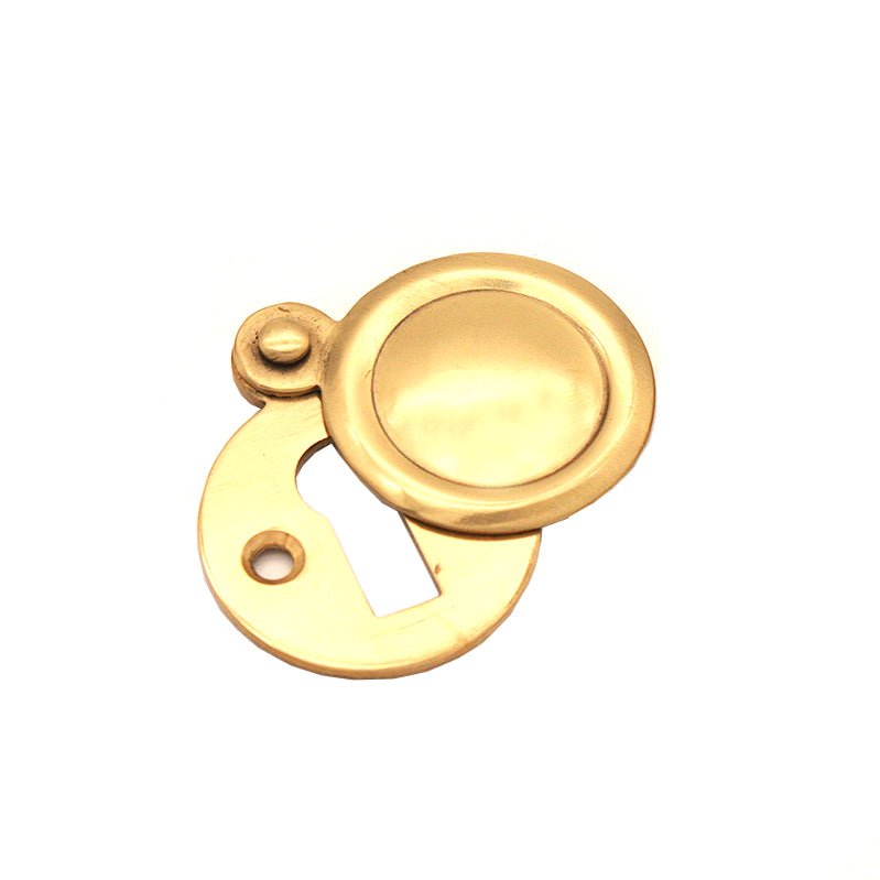 Spira Brass Victorian Key Hole Covered Escutcheon in a polished brass finish, featuring a circular design with a keyhole and a small round attachment point.