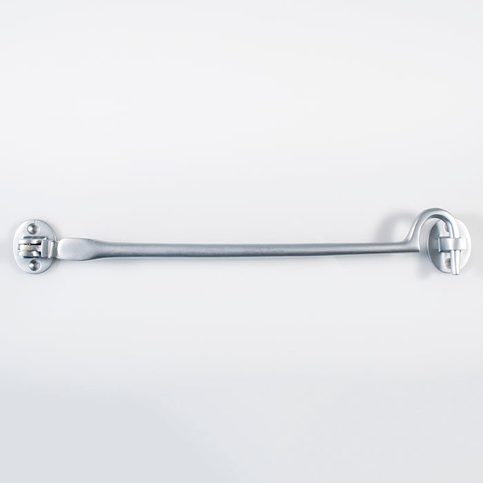 Carlisle Brass Silent Pattern Cabin Hook in a metallic finish, featuring a straight design with two circular mounting plates. It is a hardware accessory suitable for securing doors.