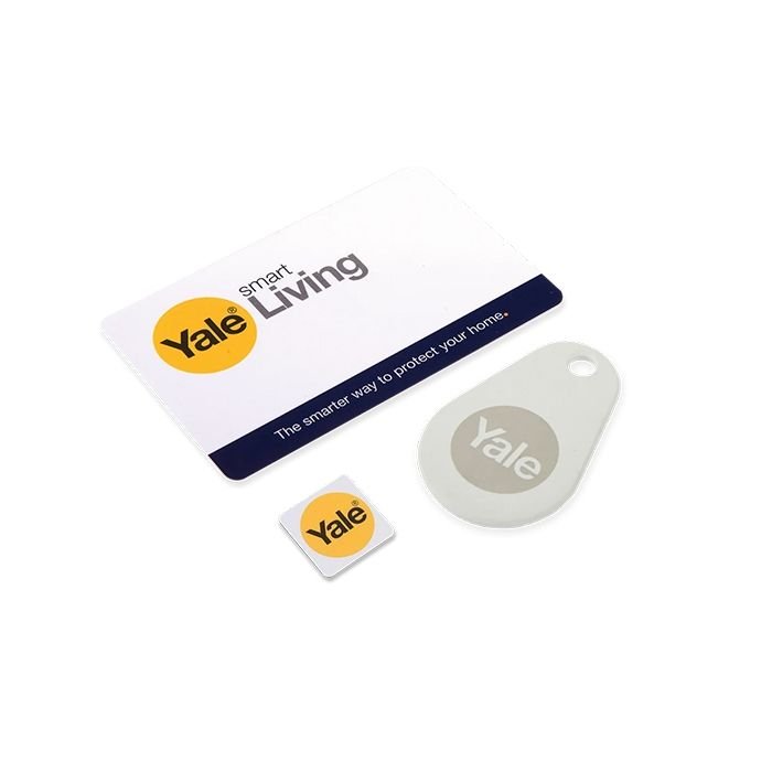 Carlisle Brass Smart Door Lock Accessory Pack includes a Yale smart living card, a key fob, and a small sticker, all featuring a yellow and gray design.