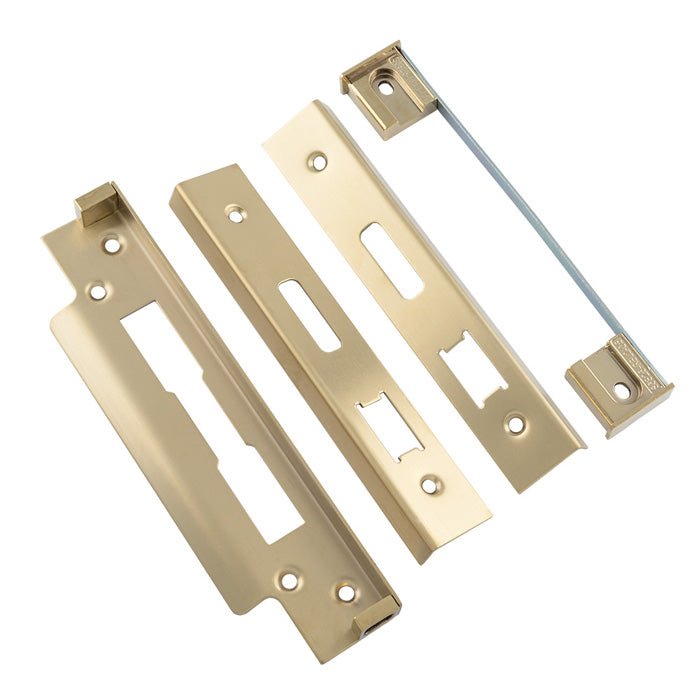 Carlisle Brass BS Rebate Set (Sash Lock) in a polished brass finish, consisting of multiple plates and a metal rod, designed for securing sash windows.