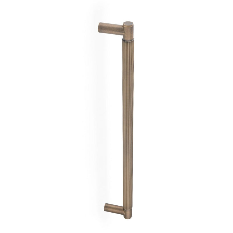 Alexander & Wilks Spitfire Reeded Pull Handle in antique brass finish, featuring a linear reeded design with rounded ends for a grip-friendly hold.