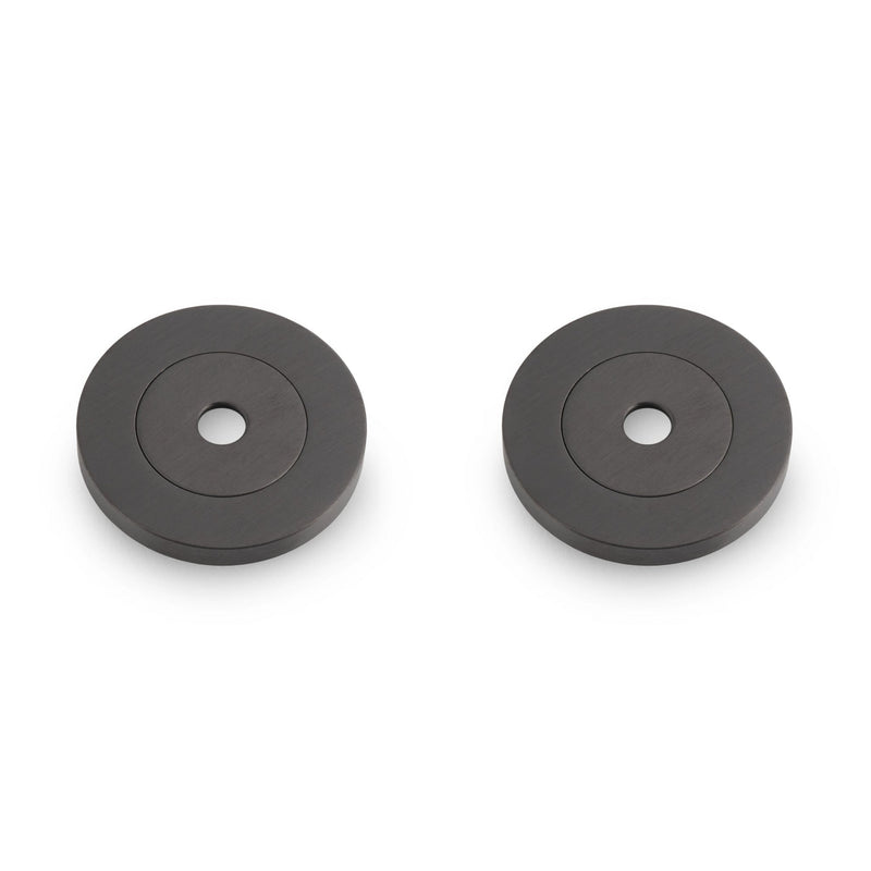 Carlisle Brass Rose Packs to Suit Pull Handles - Pair in a dark gray finish, featuring a smooth circular design with a central hole, suitable for enhancing door hardware.