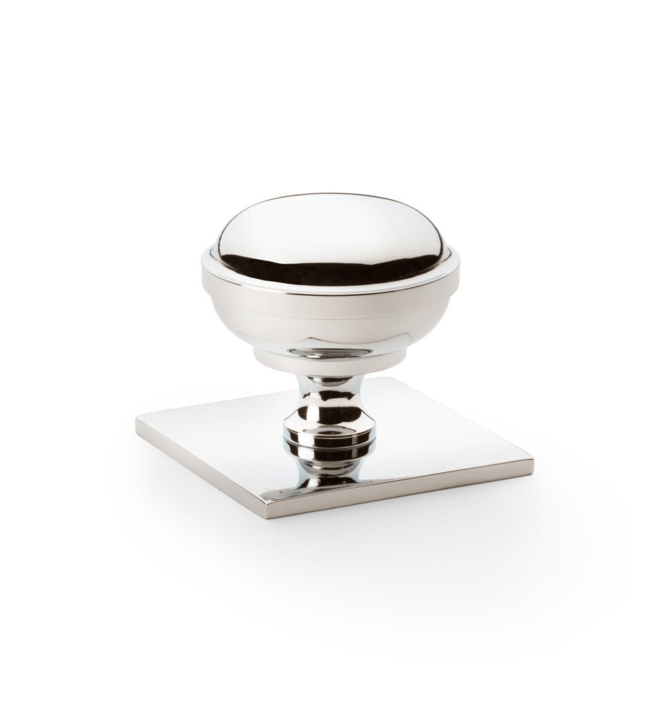 Alexander & Wilks Quantock Cupboard Knob on Square Backplate featuring a polished chrome finish. The knob has a rounded design mounted on a square backplate, providing a modern look for cabinet doors or drawers.