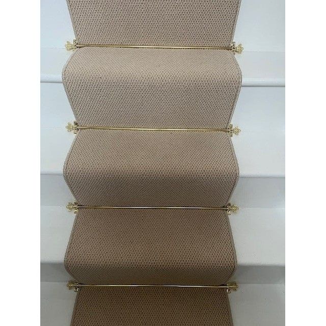 Brass bee Polished Brass Finish Stair Rods with Mushroom Finials, measuring 725mm, displayed on a stair carpet in a neutral tone, securely holding the carpet in place with decorative finials at each end.