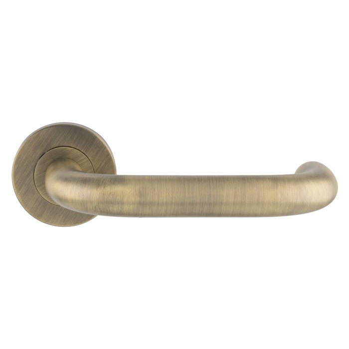 Carlisle Brass Nera Safety Lever on Sprung Rose in a brushed antique brass finish, featuring a curved handle design mounted on a round rose.