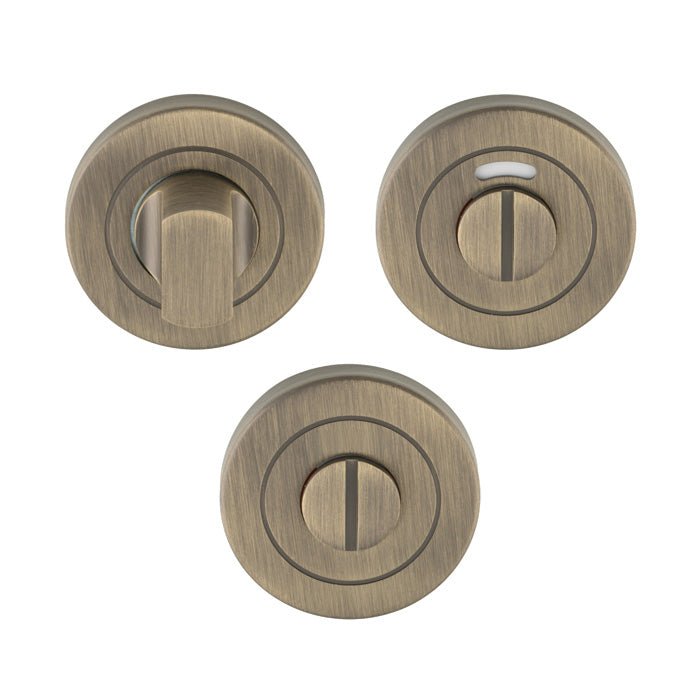 Carlisle Brass Stainless Steel Thumbturn and Release in an antique bronze finish, featuring round plates with a thumbturn and a release mechanism, designed for door installations.