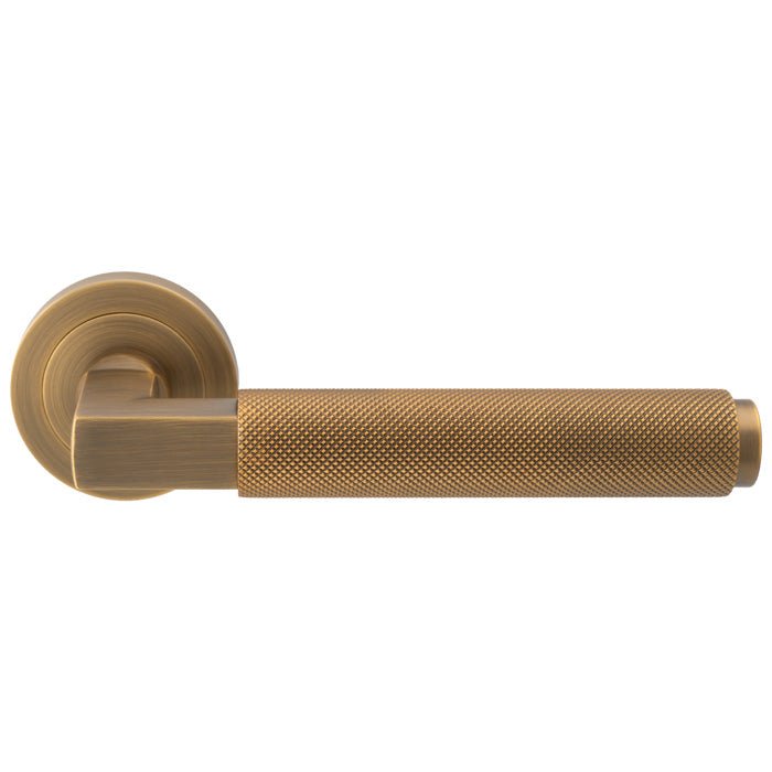 Carlisle Brass Terazzo Lever On Round Rose in a brushed gold finish, featuring a textured grip and a simple round rose plate, designed for smooth operation and durability.