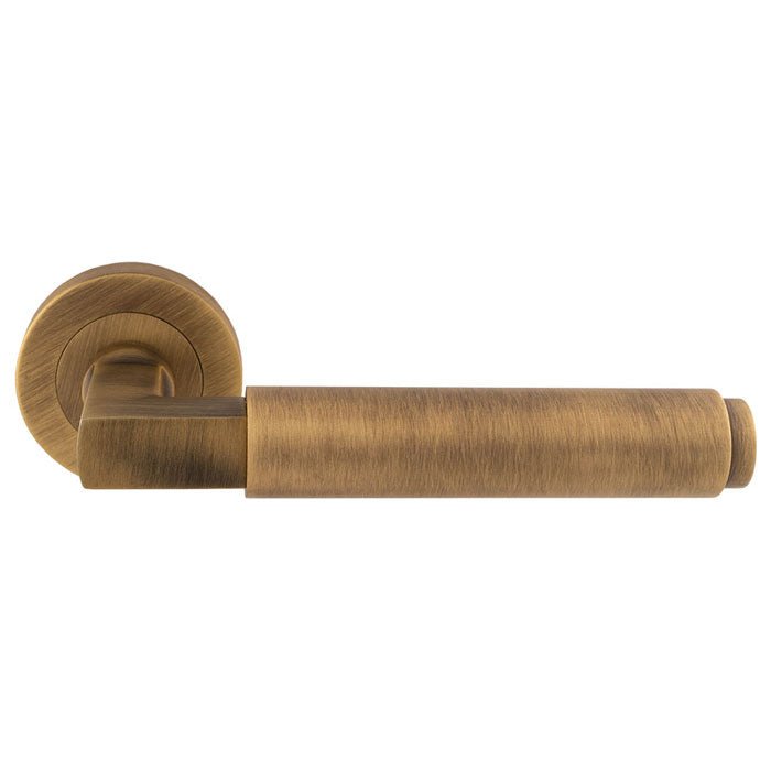 Carlisle Brass Masano Lever On Round Rose in a brushed gold finish, featuring a cylindrical lever design and a round rosette, crafted from durable metal.