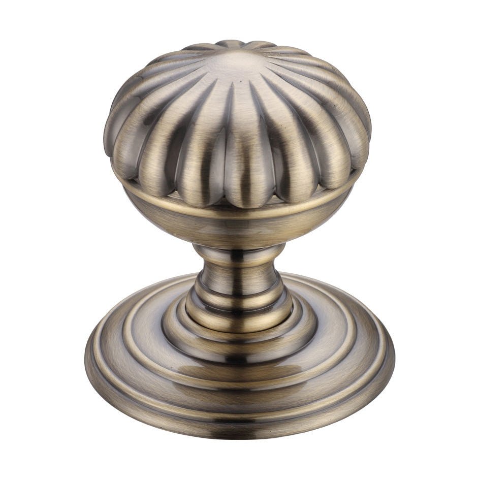 Zoo Hardware Flower Mortice Knob on Round Rose - Concealed Fix in antique brass finish, featuring a ribbed design and a rounded shape for an elegant appearance.