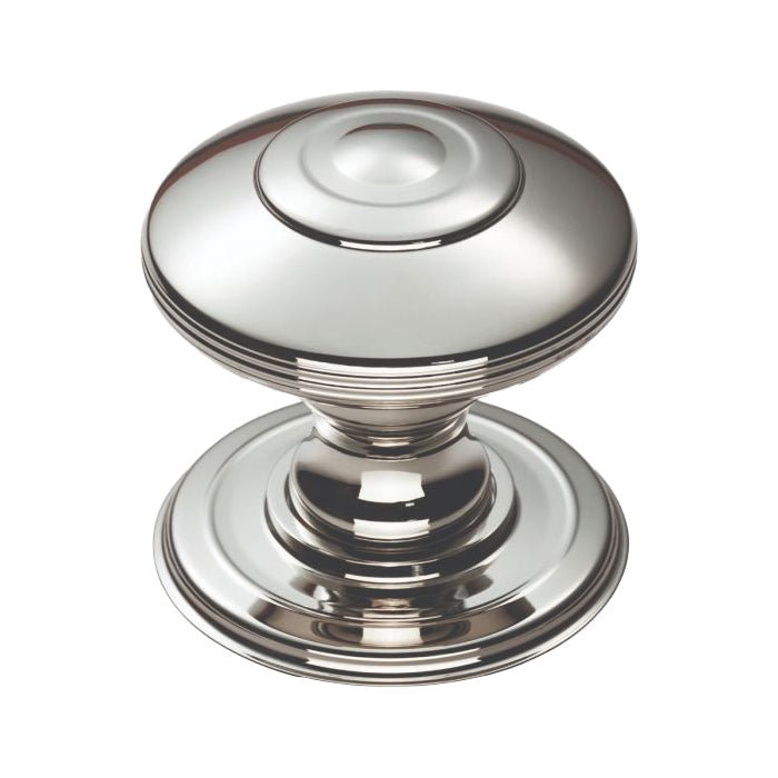 Carlisle Brass Anderson Knob with a polished chrome finish, featuring a rounded shape and concentric rings. The knob has a smooth top and a wider base, suitable for door installations.
