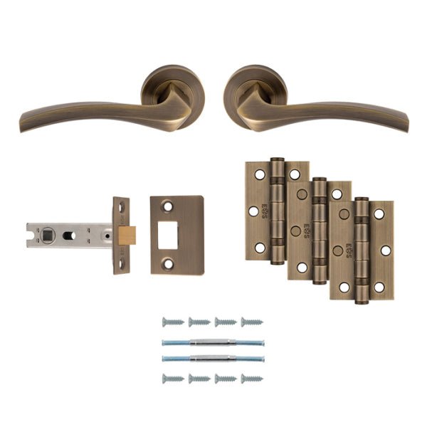 Carlisle Brass Sines Door Handle Pack featuring a lever handle, latch, and hinges in an antique brass finish, includes two door handles, a latch mechanism, four hinges, and installation screws.