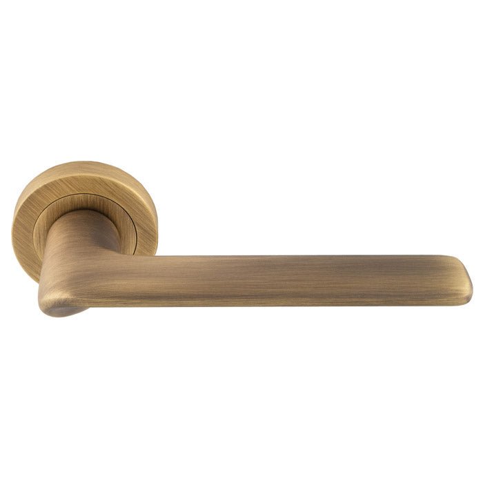Carlisle Brass Manital Vortex Lever on Rose in brushed gold finish. The lever features a sleek design mounted on a round rose plate, suitable for various interior doors.