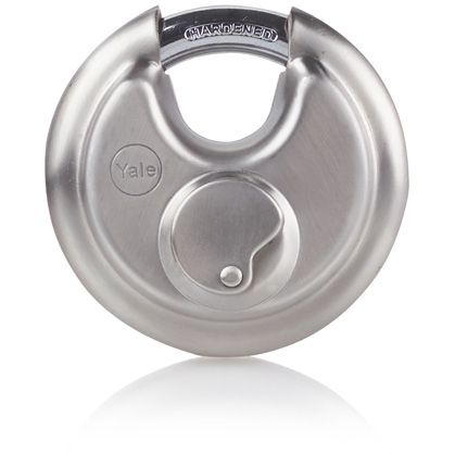 Carlisle Brass Laminated & Weatherproof Padlock featuring a hardened steel body with a metallic silver finish and a circular design. The padlock includes a side-locking mechanism for added security.