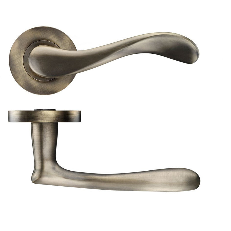 Zoo Hardware Asti lever on round rose in a brushed nickel finish, featuring a sleek, curved design for door installations. The set includes both the lever handle and the round rose plate.