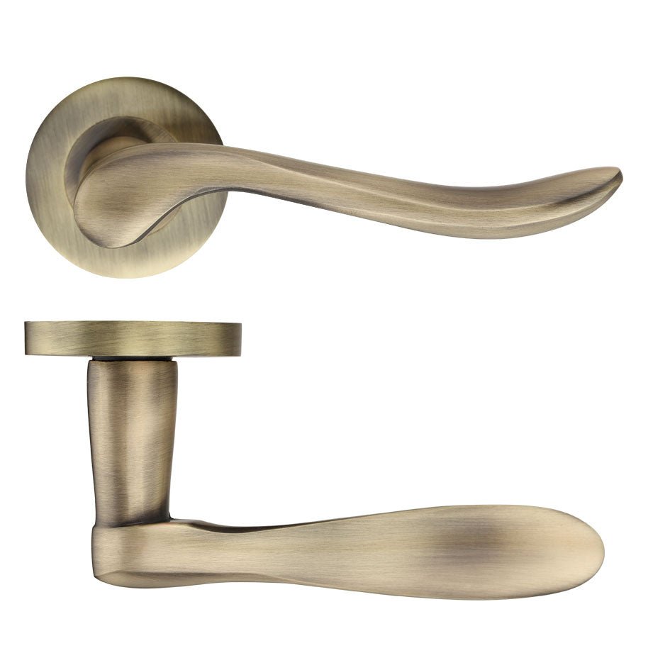 Zoo Hardware Lincoln Lever - Screw on Rose in brushed antique brass finish, featuring a curved handle design and circular rose plate for door installations.