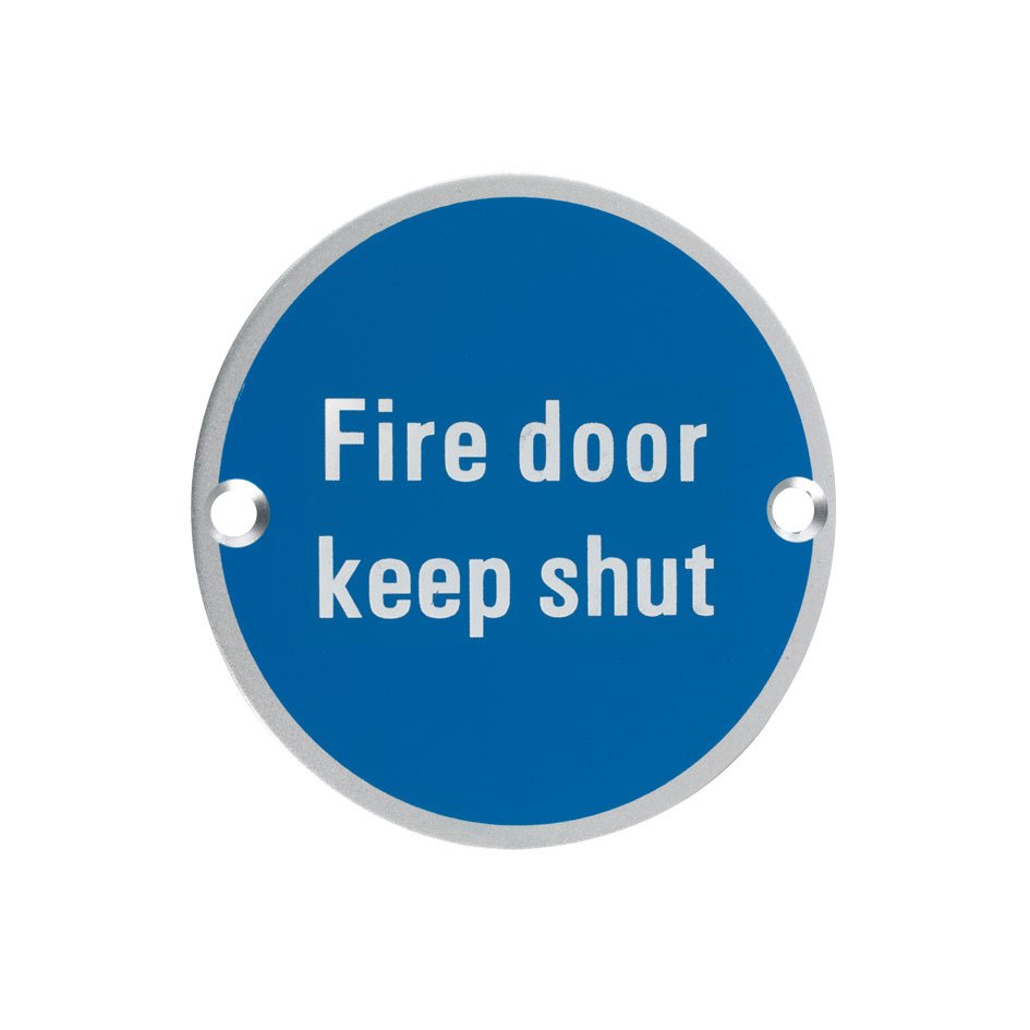 Zoo Hardware Signage - Fire Door Keep Shut in blue color with white text on a round aluminum plaque, featuring two mounting holes for easy installation.