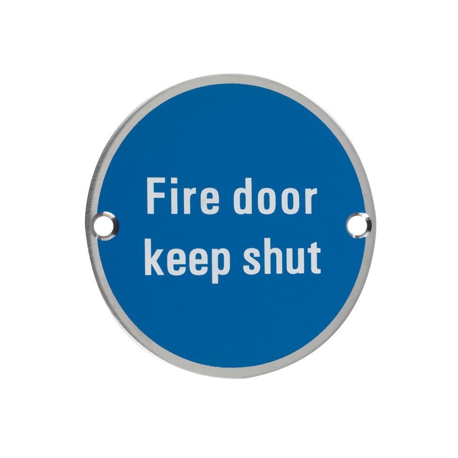 Zoo Hardware Fire Door Keep Shut Sign with a blue circular background and white text, featuring two holes for easy mounting.