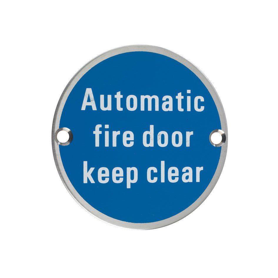 Zoo Hardware Automatic Fire Door Keep Clear Sign, featuring a circular blue background with white text that reads "Automatic fire door keep clear," and two holes for mounting.